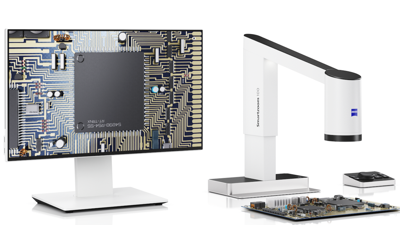 Digital microscope setup from ZEISS showing a detailed circuit board image on a monitor beside the microscope examining an electronic component.